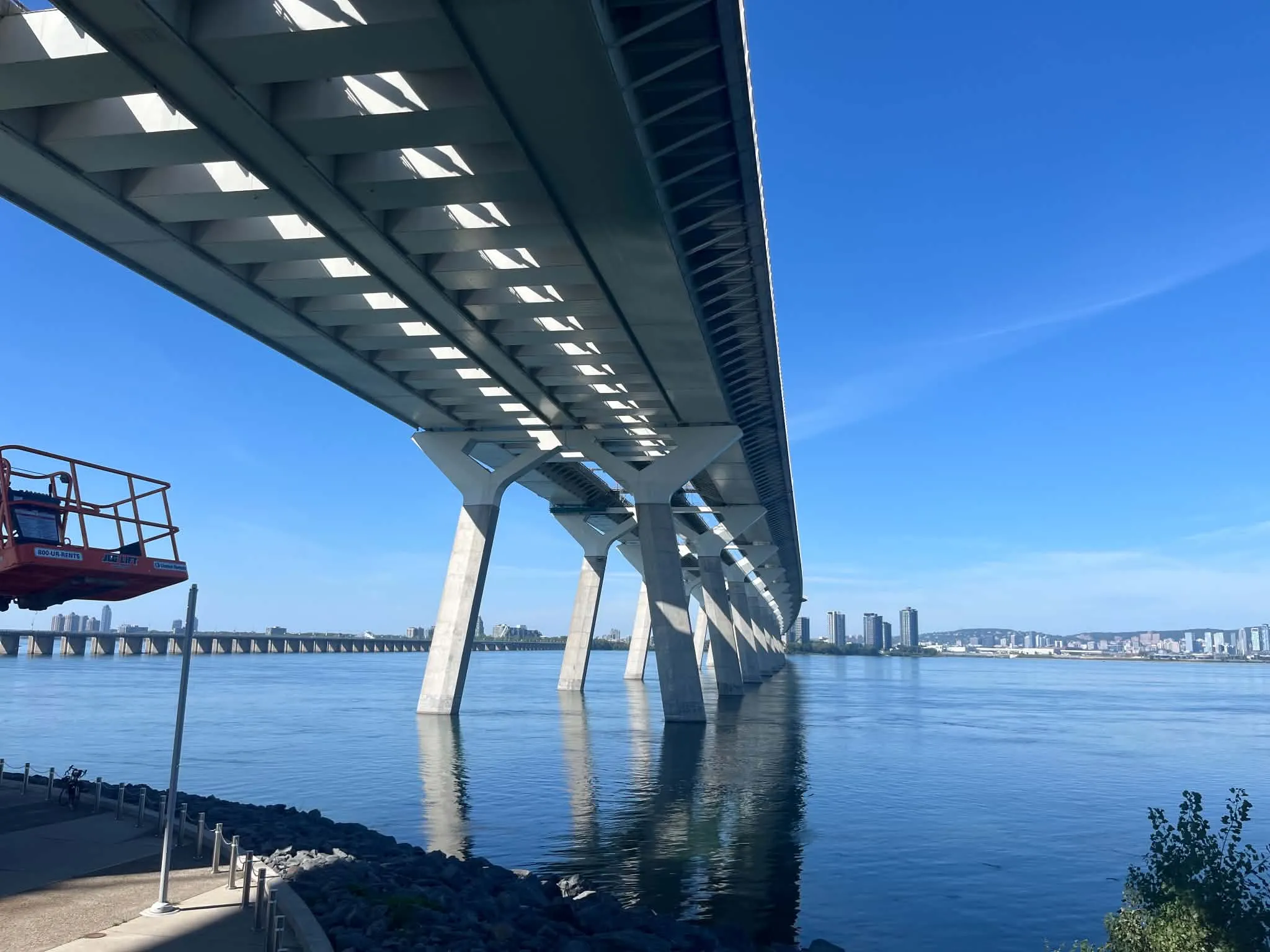 A bridge stretching over open water on a clear blue day
